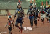 A ukre village Brazil Two Kayapo boys jumping into the 